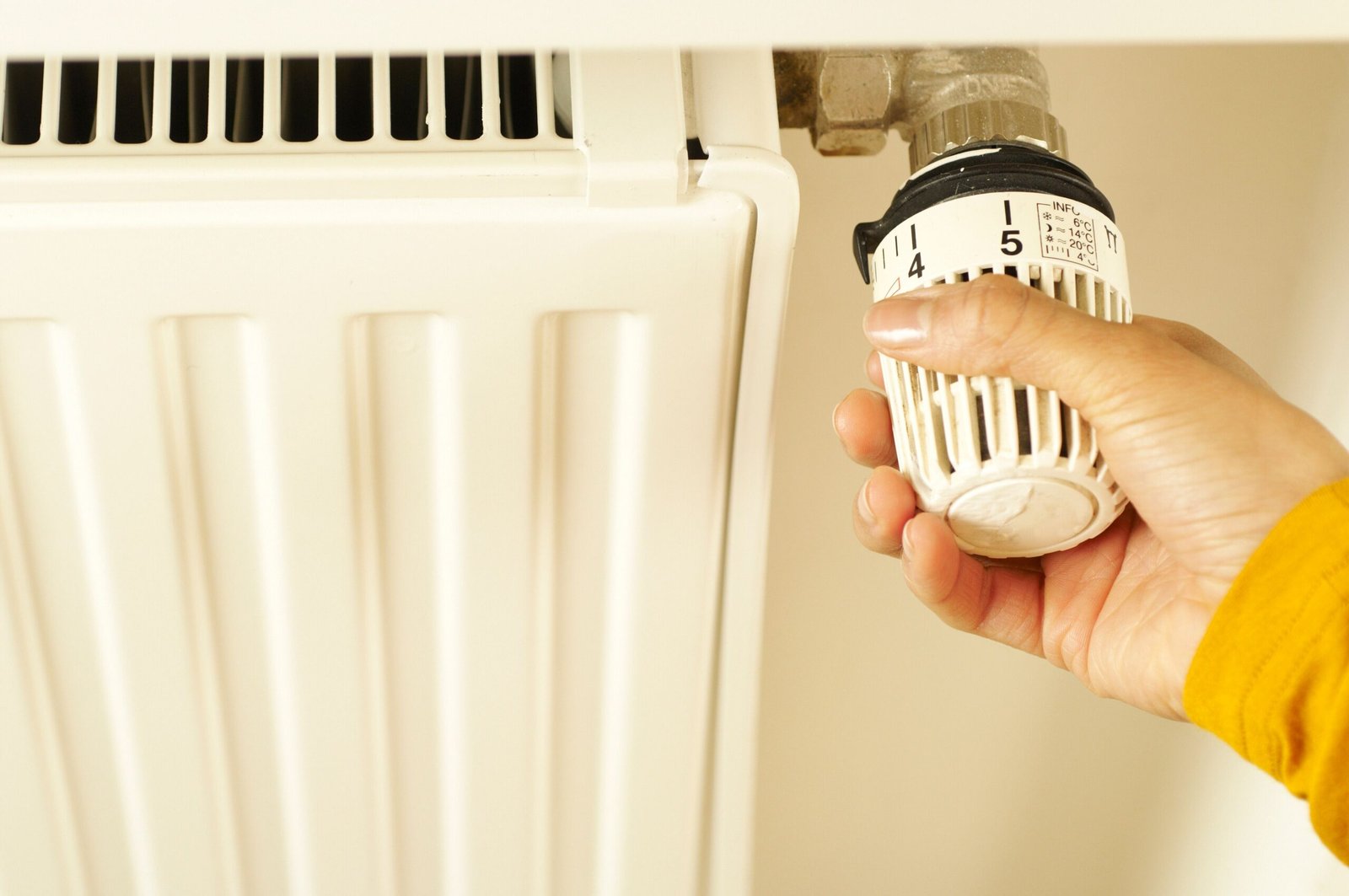 House owner adjusting radiator control